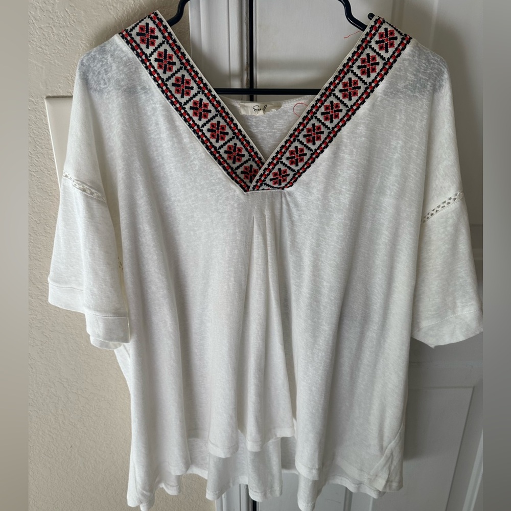 Small white flowy shirt with pattern on the top